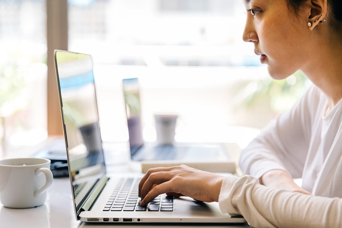 Student at desk working on laptop