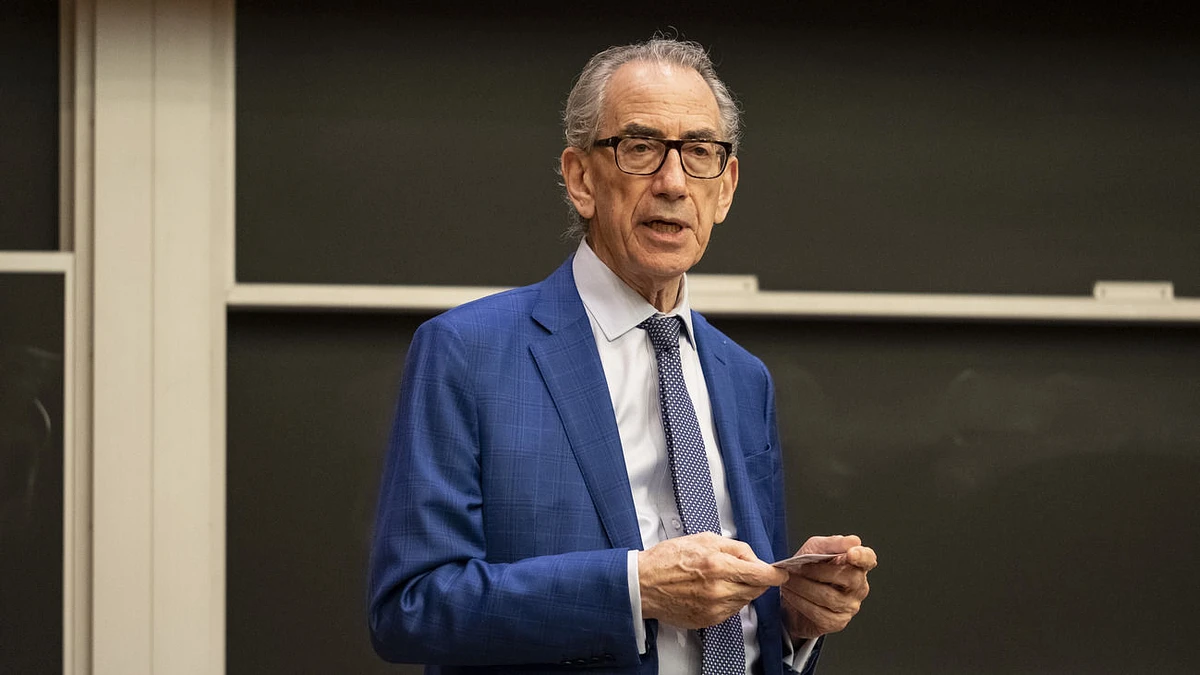 A man in a suit and tie speaking