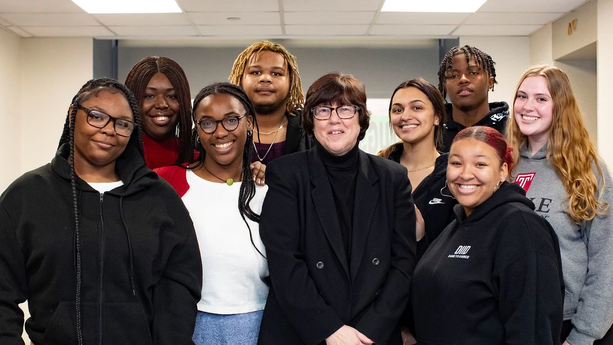 Tricia Jones (center) interacts with interns and students from Resolutionary Partners, the program she created to decrease violence in Philadelphia. From left to right: Nae Brown, Tosin Sanni, Nya Jarboe, Dante Harrell, Tricia Jones, Katie Weissenberg, Javon Clements, Ciara Chase and Carissa George.
