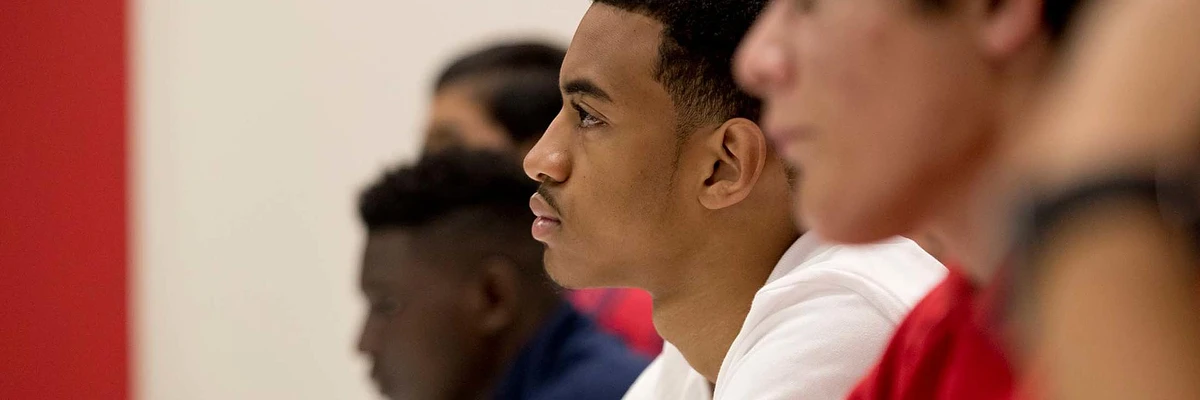 A group of focused individuals sitting and paying attention.